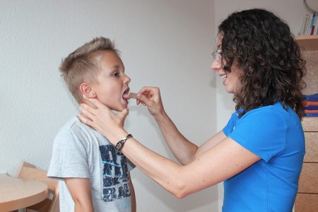 Logop&auml;din testet mit Holzpl&auml;ttchen die Zungenber&uuml;hrung